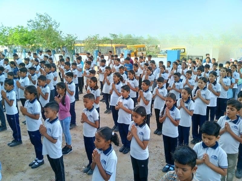Faculty guiding students at assembly — Dunes Academy Phalodi