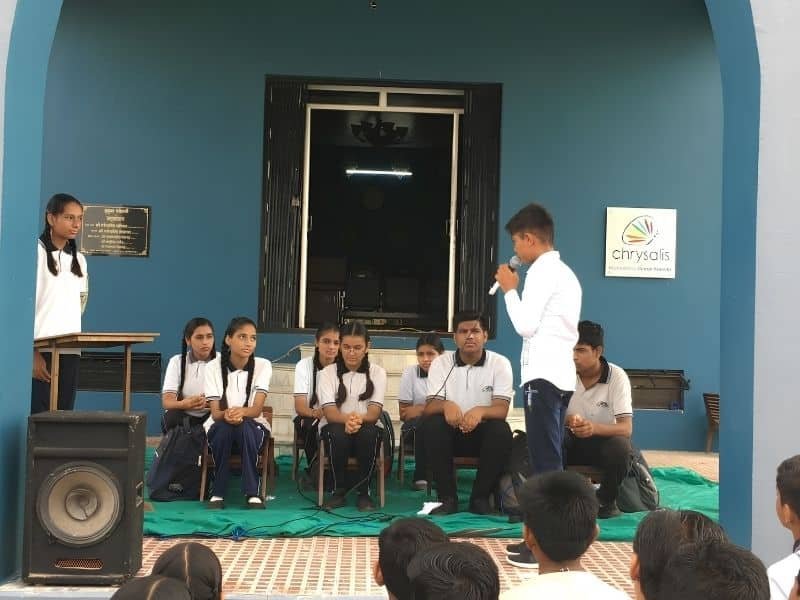 Students participating in quiz competition at Dunes Academy achievements event