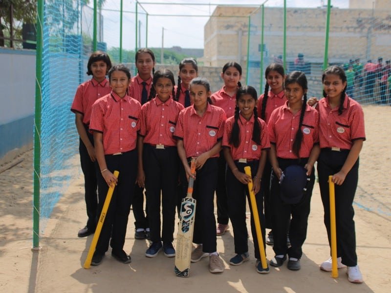 Students playing cricket on the Dunes Academy sports ground