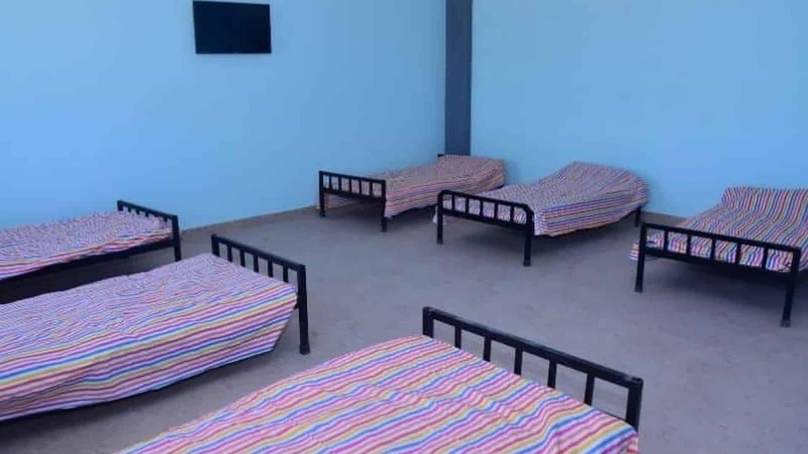 Student dormitory with beds at the Dunes Academy boarding wing